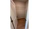 Walk-in closet with ventilated shelving and wood-look flooring at 2814 Vogler Ln, North Port, FL 34286