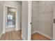 Hallway leading to a bathroom with a glass-enclosed shower and neutral color palette throughout at 2814 Vogler Ln, North Port, FL 34286