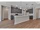 Modern kitchen with gray cabinetry, a large central island, and stainless steel appliances and white countertops at 2814 Vogler Ln, North Port, FL 34286