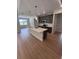 Open-concept kitchen with island, stainless steel appliances, and gray cabinets at 2814 Vogler Ln, North Port, FL 34286