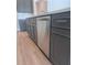 Modern kitchen with gray cabinets, stainless steel appliances, and white countertops at 2814 Vogler Ln, North Port, FL 34286