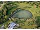 Aerial view of a natural lake with beach, lounge chairs and green landscaping at 2814 Vogler Ln, North Port, FL 34286