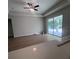 Open-concept living area featuring modern ceiling fan and patio door at 2814 Vogler Ln, North Port, FL 34286