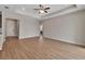 Spacious living room featuring tray ceilings, wood-look flooring, recessed lighting, and neutral walls at 2814 Vogler Ln, North Port, FL 34286