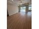 Large living room area with wood floors, a tray ceiling, recessed lighting, and sliding doors to the outdoors at 2814 Vogler Ln, North Port, FL 34286
