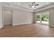 Bright living room with tray ceilings, recessed lighting, wood-look flooring, and a sliding glass door at 2814 Vogler Ln, North Port, FL 34286