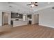 Open floor plan showcasing kitchen with gray cabinets and island, and a living area with tray ceilings at 2814 Vogler Ln, North Port, FL 34286
