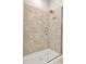 Bathroom with tiled shower, glass door, and modern fixtures at 2814 Vogler Ln, North Port, FL 34286