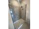 Modern shower featuring glass doors and stone-look tile surround at 2814 Vogler Ln, North Port, FL 34286