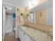 Bathroom featuring a granite countertop vanity, decorative fish decor, and a step-in shower at 3310 Loveland Blvd # 802, Punta Gorda, FL 33980