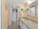 Bathroom featuring a granite countertop vanity, decorative fish decor, and a step-in shower at 3310 Loveland Blvd # 802, Punta Gorda, FL 33980