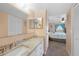 Bathroom featuring a granite countertop vanity and mirror, with a partial view of the bedroom at 3310 Loveland Blvd # 802, Punta Gorda, FL 33980