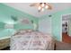 Bright bedroom featuring a floral bedspread, lighted ceiling fan, and ample closet space at 3310 Loveland Blvd # 802, Punta Gorda, FL 33980
