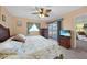 Bright bedroom with a sliding glass door to the outside, neutral colors, and a ceiling fan at 3310 Loveland Blvd # 802, Punta Gorda, FL 33980