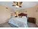 Comfortable bedroom featuring a decorative ceiling fan, a queen-sized bed, and soft, neutral colors at 3310 Loveland Blvd # 802, Punta Gorda, FL 33980