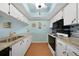 Galley kitchen with granite counters, tile backsplash and bright lighting at 3310 Loveland Blvd # 802, Punta Gorda, FL 33980