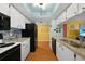 Galley kitchen features granite counters, black appliances, and an adjacent eat-in kitchen at 3310 Loveland Blvd # 802, Punta Gorda, FL 33980
