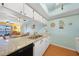 Bright eat-in kitchen with granite counters is open to living room and water view at 3310 Loveland Blvd # 802, Punta Gorda, FL 33980