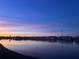 Stunning lake view at dusk with vibrant sunset reflecting on the water at 3310 Loveland Blvd # 802, Punta Gorda, FL 33980