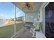 Relaxing screened lanai with seating area and view of lush landscaping and pond at 3310 Loveland Blvd # 802, Punta Gorda, FL 33980