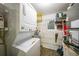 Functional laundry room with stacked washer/dryer, shelving, and utility sink at 3310 Loveland Blvd # 802, Punta Gorda, FL 33980