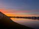 Sunset over the community lake offers a picturesque view from your condo at 3310 Loveland Blvd # 802, Punta Gorda, FL 33980