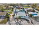 Aerial view of a fenced property with tropical landscaping, patio and a white gravel yard at 539 Shore Rd, Nokomis, FL 34275