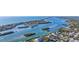 Stunning aerial view of waterfront homes nestled along scenic waterways, with boats gliding through the tranquil waters at 539 Shore Rd, Nokomis, FL 34275