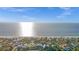 Stunning aerial view of beachfront homes with clear blue ocean and sky on a sunny day at 539 Shore Rd, Nokomis, FL 34275