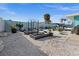 Backyard featuring raised garden beds, lounge area, and meticulously maintained landscaping at 539 Shore Rd, Nokomis, FL 34275