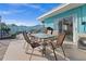 Outdoor patio with modern glass-topped dining set perfect for al fresco dining and entertainment at 539 Shore Rd, Nokomis, FL 34275