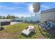 Large fenced backyard with lawn, patio, and a cornhole game at 539 Shore Rd, Nokomis, FL 34275