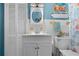 Bright bathroom featuring a seashell themed decor, and a white vanity sink at 539 Shore Rd, Nokomis, FL 34275