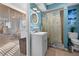 Bathroom featuring tiled floor, single sink vanity, round mirror, and shower with coastal-themed curtain at 539 Shore Rd, Nokomis, FL 34275