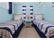 Nautical themed bedroom with two twin beds and blue walls for a seaside retreat at 539 Shore Rd, Nokomis, FL 34275