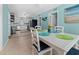 Dining area showcasing a white table with seating for four and open access to the kitchen at 539 Shore Rd, Nokomis, FL 34275