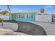 Attractive blue single-story home with paved driveway and fenced-in yard, providing privacy and a pop of color at 539 Shore Rd, Nokomis, FL 34275