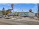 Quaint turquoise home with a yellow door, blue shutters and charming rope fence and palm trees at 539 Shore Rd, Nokomis, FL 34275