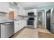 Modern kitchen featuring stainless steel appliances, white cabinets, and a tile backsplash at 539 Shore Rd, Nokomis, FL 34275