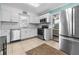 Bright kitchen with white cabinets, stainless steel appliances, and access to the bedroom at 539 Shore Rd, Nokomis, FL 34275