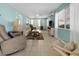 Relaxing living room with natural light, tile floors, and comfortable seating at 539 Shore Rd, Nokomis, FL 34275