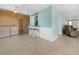 Open living area with a bar counter, laundry appliances and a tiled floor at 539 Shore Rd, Nokomis, FL 34275