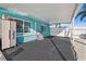 A covered patio featuring black asphalt, the exterior house paint and white painted privacy fences at 539 Shore Rd, Nokomis, FL 34275