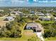 Aerial view of a charming home, surrounded by lush trees, in a quiet residential area at 7442 Clearwater St, Englewood, FL 34224