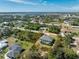 Aerial view featuring the screened-in pool area within a lovely treed and landscaped back yard at 7442 Clearwater St, Englewood, FL 34224