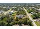 Aerial view of the property showcasing its location in a well-treed residential neighborhood at 7442 Clearwater St, Englewood, FL 34224