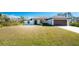 Charming single-story home featuring a well-manicured lawn and attached two-car garage at 7442 Clearwater St, Englewood, FL 34224
