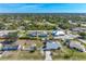 Stunning aerial view showcasing the neighborhood, nearby greenery, and proximity to community amenities at 7586 Sea Mist Dr, Port Charlotte, FL 33981
