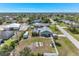 Backyard with fire pit, tropical landscaping, and a white fence in a quiet neighborhood at 7586 Sea Mist Dr, Port Charlotte, FL 33981
