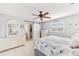Bright bedroom boasts ceiling fan, dresser, and sliding closet door, offering comfort and functionality at 7586 Sea Mist Dr, Port Charlotte, FL 33981